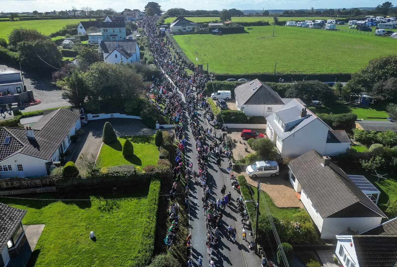 Runners and supporters filling the road past Broadfield Farm on Ironman Wales race day