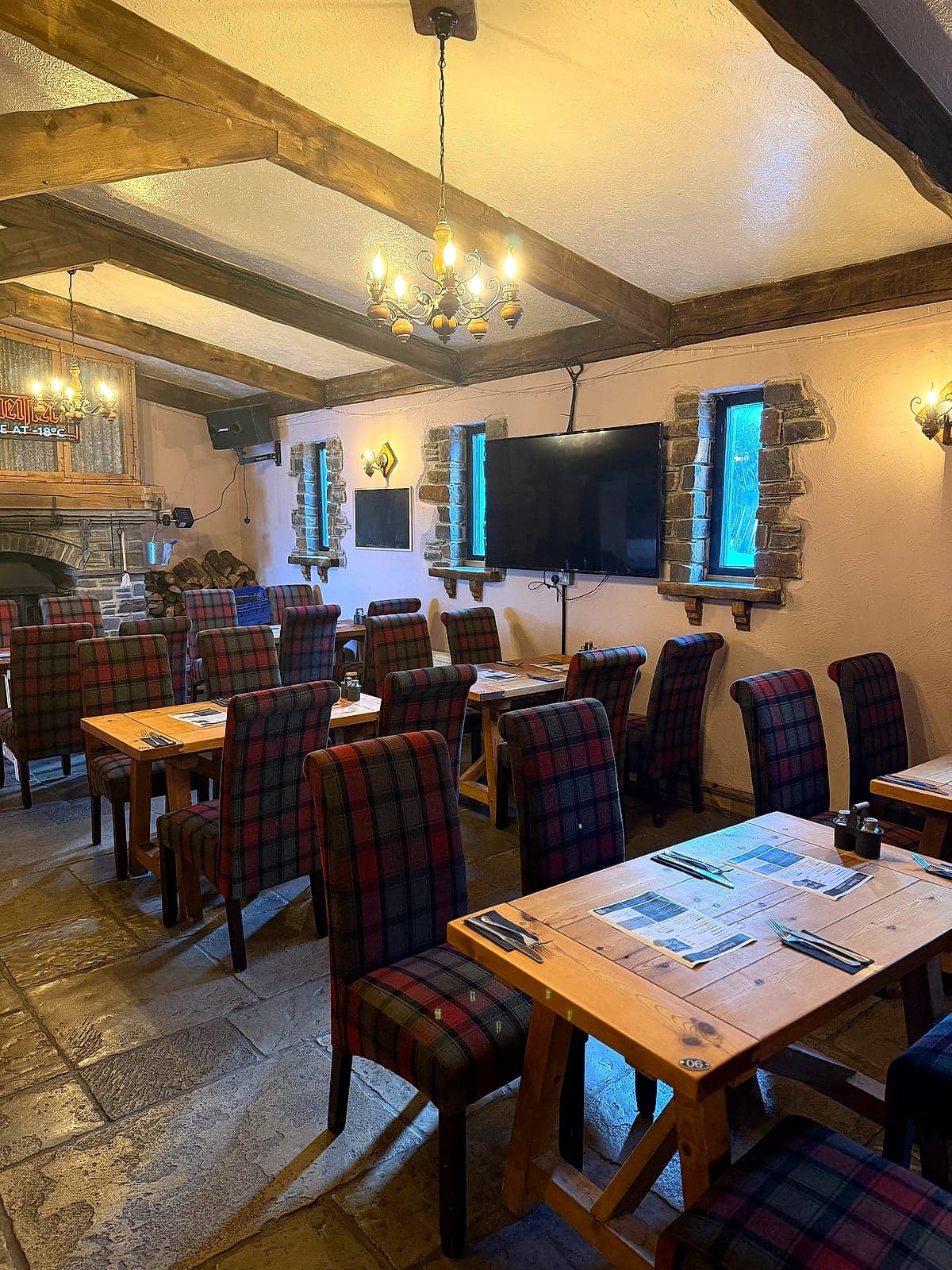 The restaurant at Jan'z, with oak beams, candle chandeliers and tartan chairs